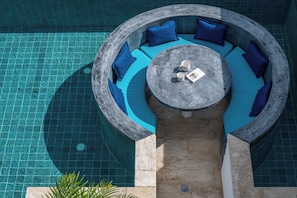 A circular outdoor seating area with blue cushions and a central table with a magazine and two cups. - Villa Satori 3 Bed Seaview Infinity Pool (Bophut, Koh Samui)