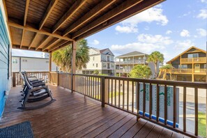 A wooden deck with a railing, a bench, and a view of a residential area with houses and a clear sky. - Family Tides - Spacious 6BR Duplex, Two Full Floors w/ Private Balconies (Walk to Beach) (North Myrtle Beach)