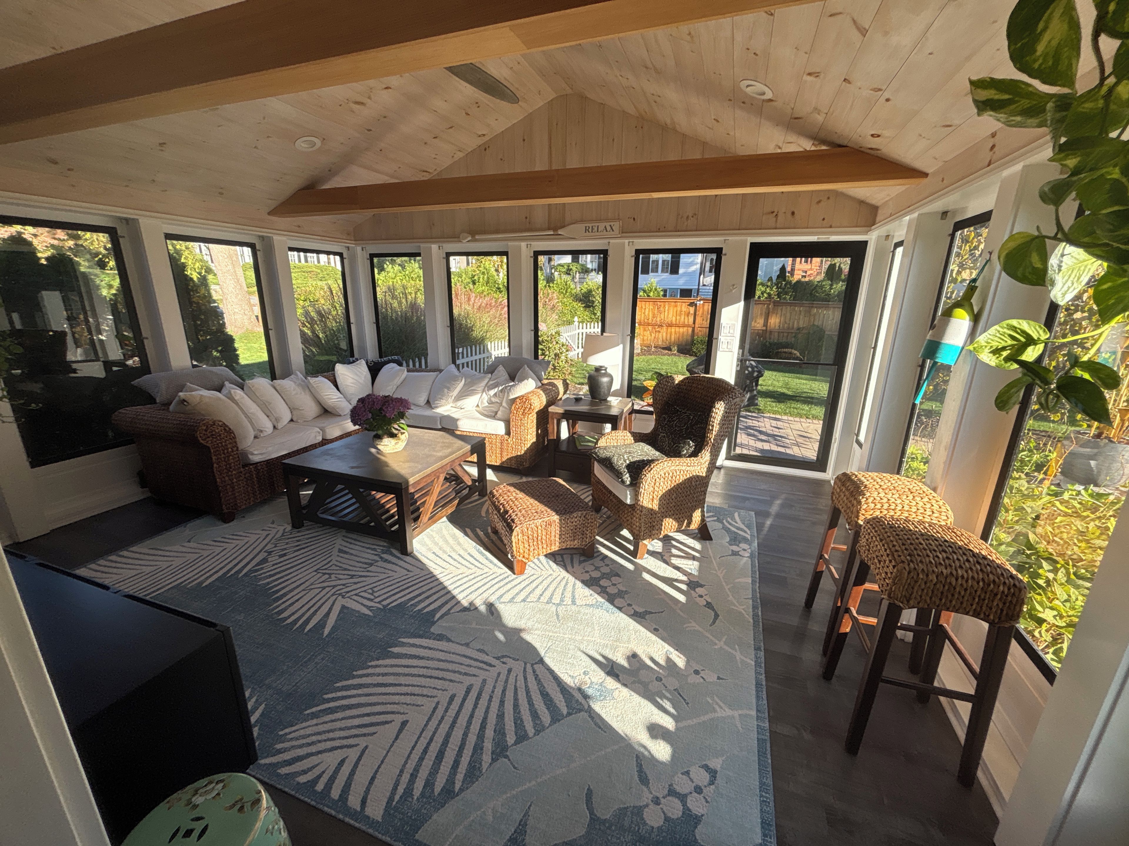A sunlit room with a sofa, chairs, and a coffee table.