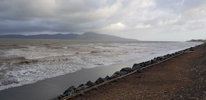 A coastal view with a rocky shoreline and waves.
