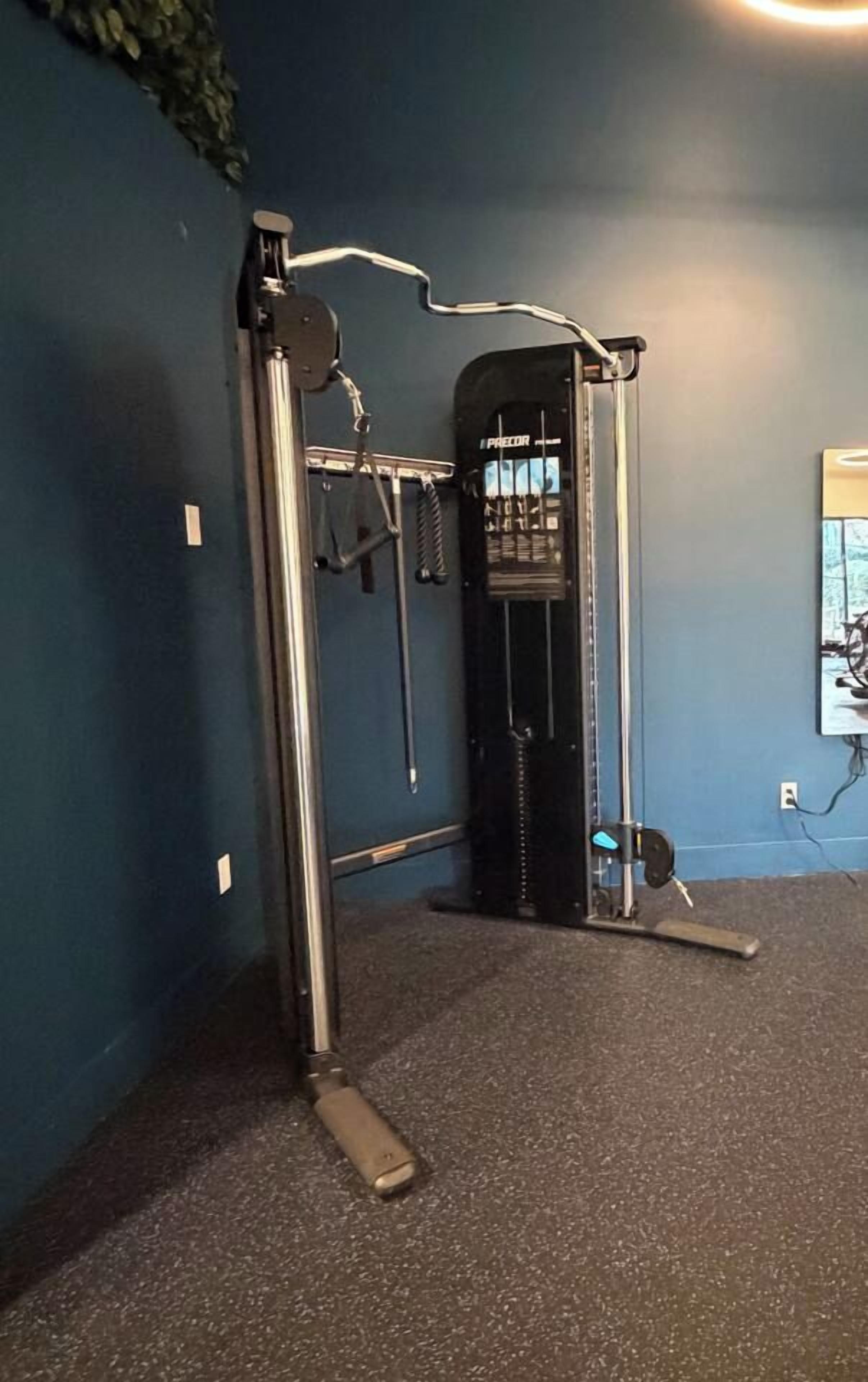 A gym with a pull-up bar, a squat rack, and a bench.