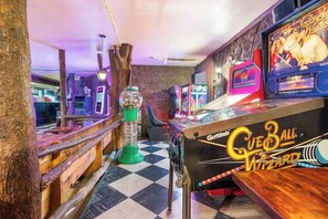A vintage arcade with a claw machine and a bowling game. - The Funky Flamingo Lake Retreat-Walk to the Park/Fishing/Boating (Rockaway Beach)