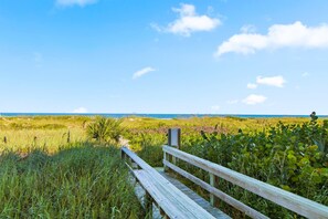 A wooden boardwalk leading to a beach with a clear sky. - Wake Up to the Atlantic: On-the-Beach Cocoa Beach Condo w/ Heated Pool & Beach Gear (Cocoa Beach)
