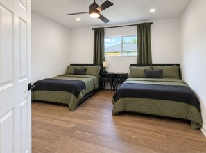 A bedroom with two beds, a desk, a ceiling fan, and a window with curtains. - Heights Gem Chef's Kitchen 5 Min to Downtown (Houston)