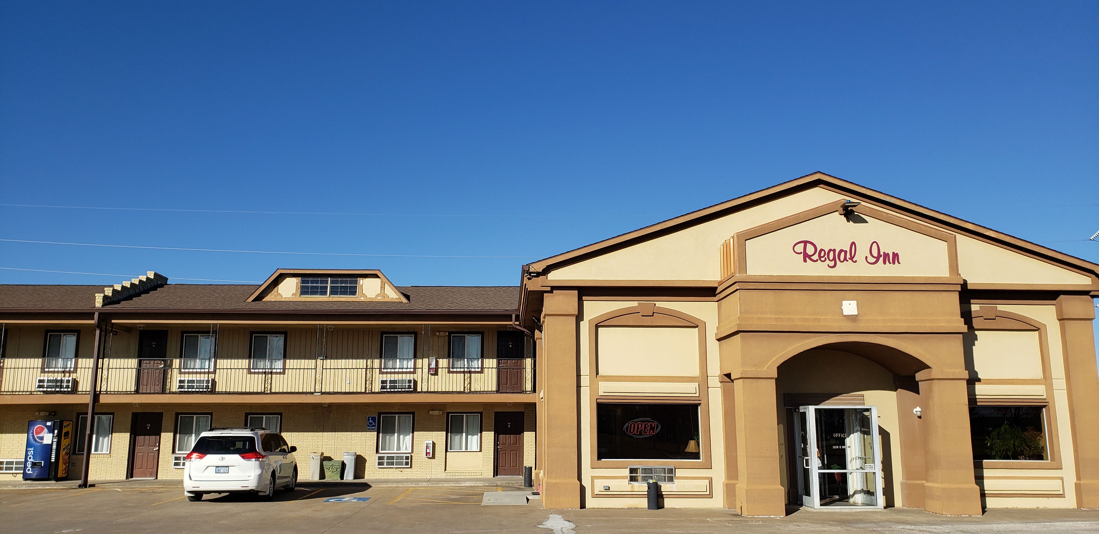A two-story building with a sign reading 'Regal Inn' above the entrance.