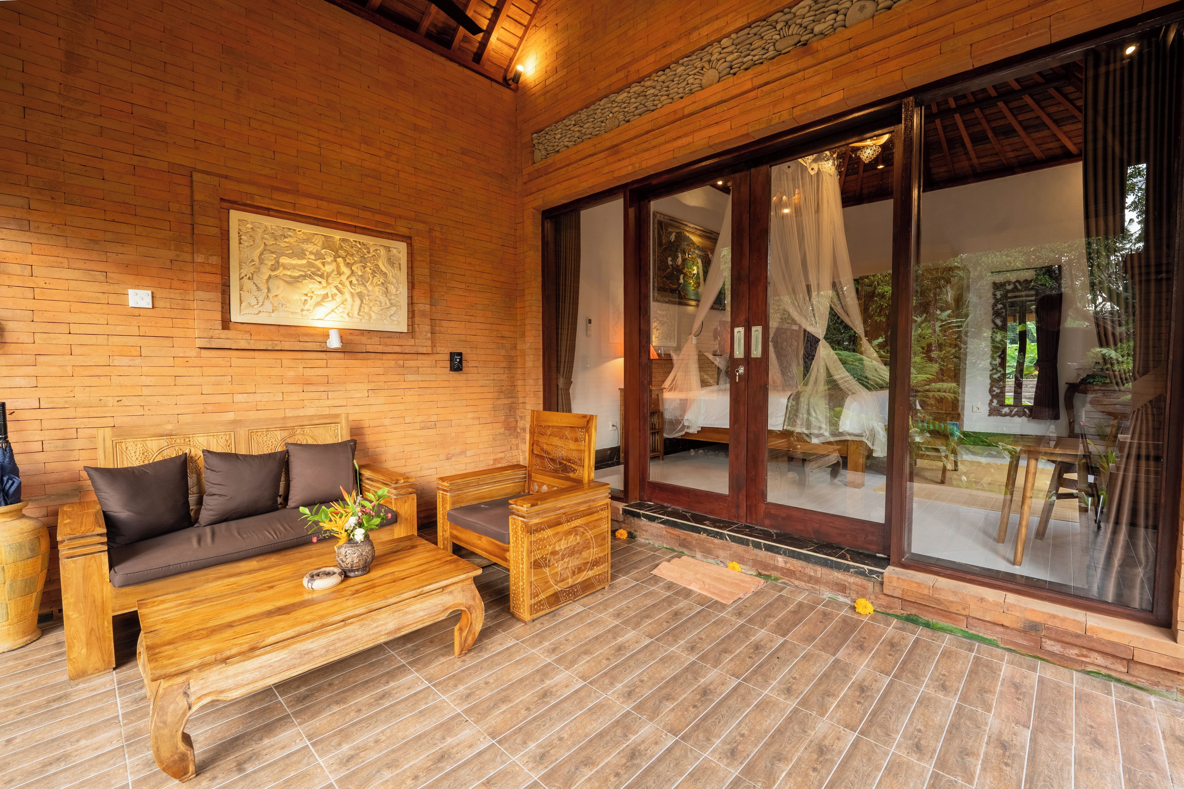 A wooden interior with a sofa, a wooden table, and a bench.