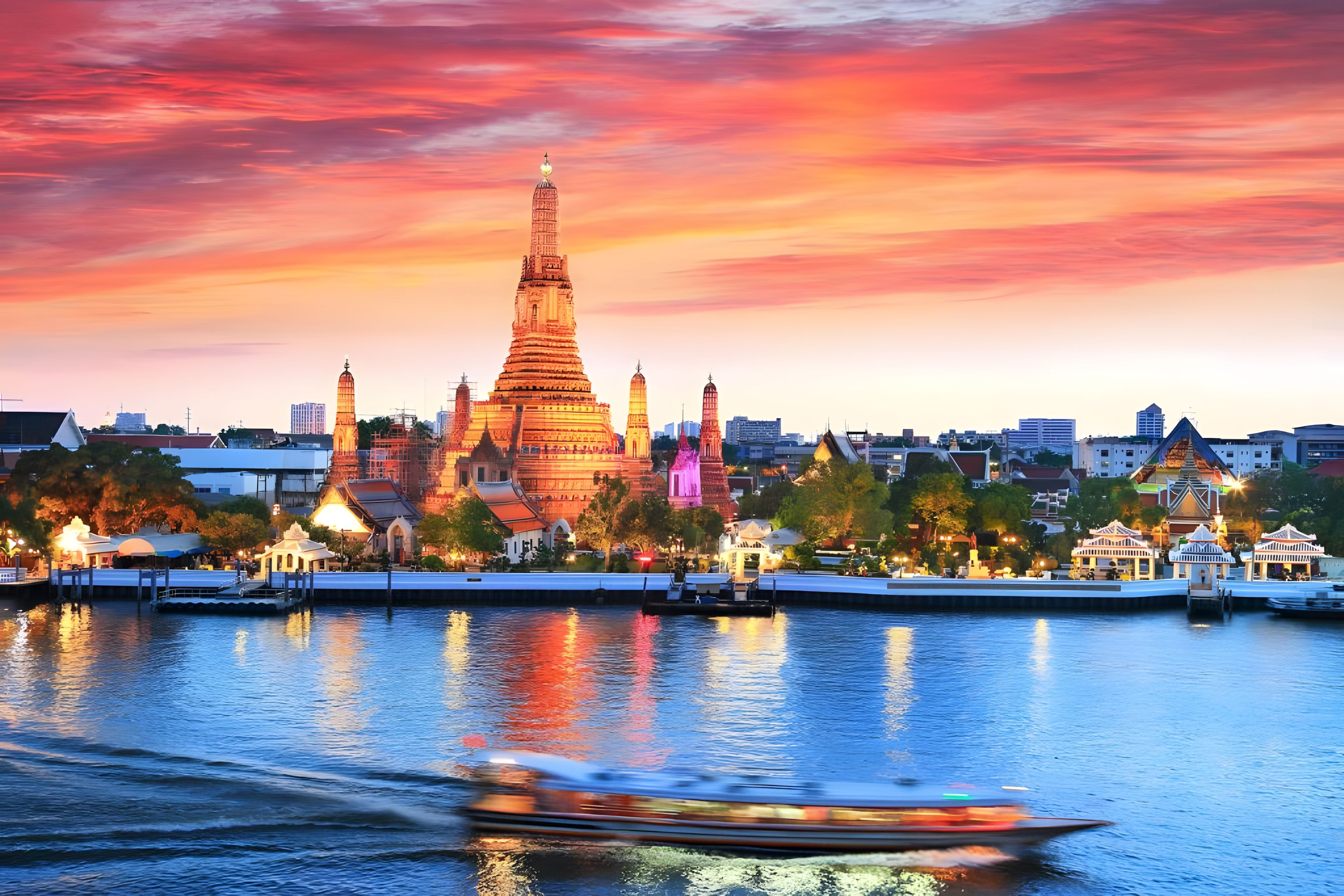 A waterfront view of a city with a prominent temple and modern buildings.