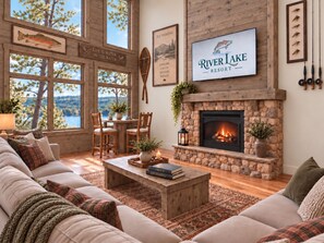 Un salon chaleureux avec une cheminée, de grandes fenêtres et une enseigne indiquant le nom de l’établissement : River Lake Resort.