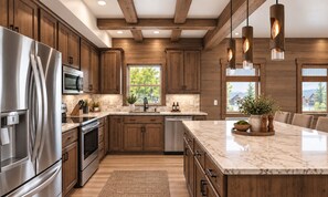 A modern kitchen with wooden cabinets, stainless steel appliances, and a marble countertop. - New Lakefront Lodge | Beautiful Views | Pool, ChipnPutt, Fire Pit (Hollister)