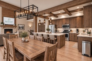A spacious kitchen with wooden cabinets, a central island, and modern appliances. - New Lakefront Lodge | Beautiful Views | Pool, ChipnPutt, Fire Pit (Hollister)