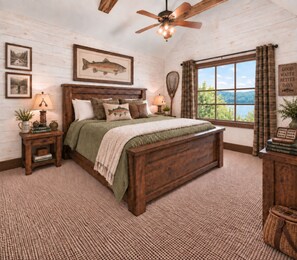 A bedroom with a wooden bed, a ceiling fan, a window with a view, and a wall with framed pictures. - Lakefront Lodge | River Views & Resort Fun | Pool, Golf & Dock (Hollister)