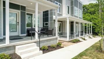 Modern exterior with covered porch seating and stylish curb appeal