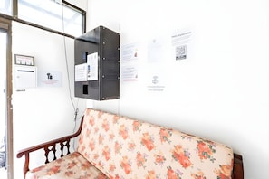 A room with a wooden bench, a wall-mounted electrical box, and various papers and notices. - M room Sukhumvit 2 (Bangkok)