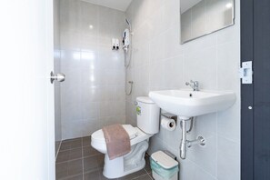Un baño con inodoro, lavabo y espejo.