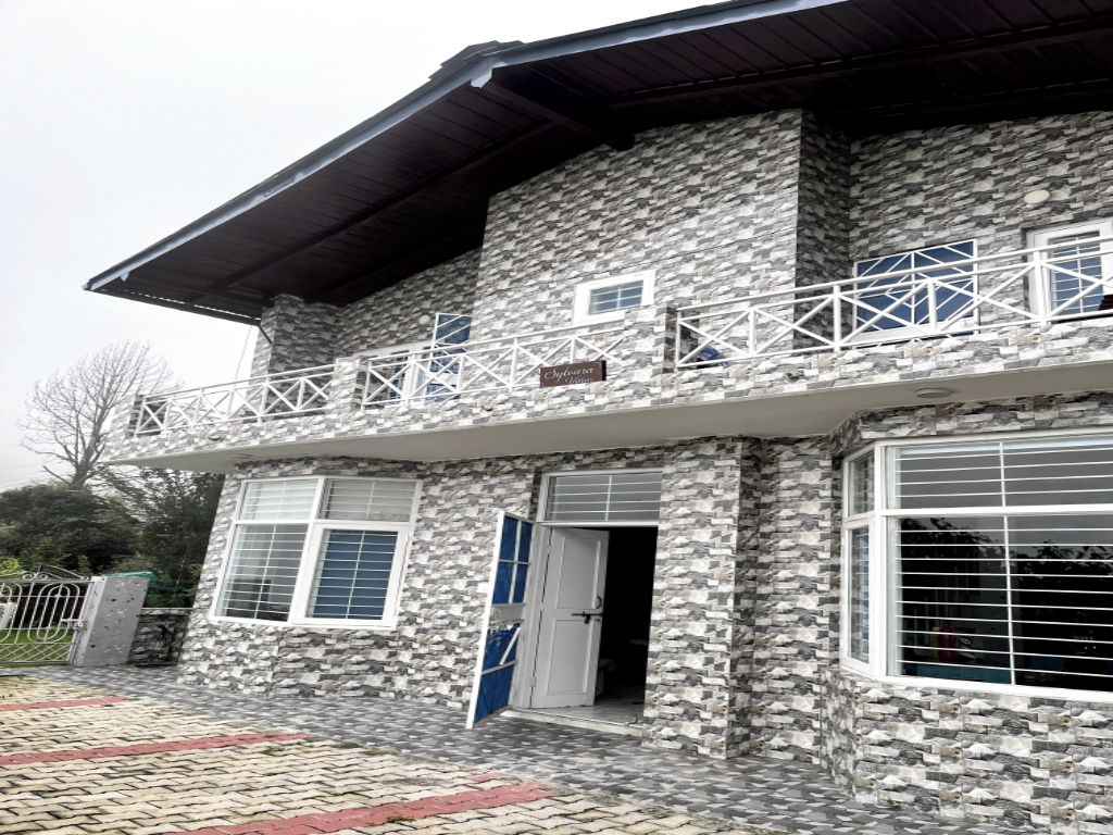 Un edificio de piedra con un balcón, una puerta y una ventana.
