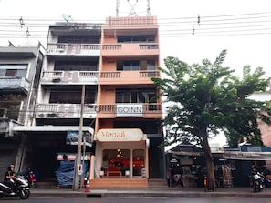 A multi-story building with a 'GOIN' sign, a 'Monai' sign, and a small outdoor seating area. - A room Asiatique (Bang Kho Laem)