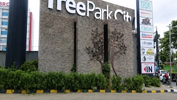 A building with a sign reading 'TreePark City' and a vertical sign with various business logos.