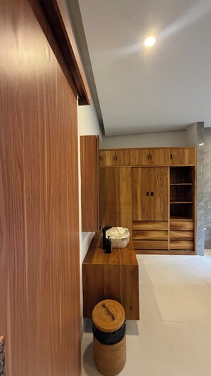 A modern interior with wooden cabinetry and a small stool.