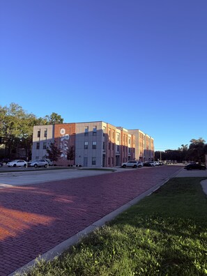 A multi-story building with a brick facade and a flat roof. - *NEW* Lawrencian Loft 2BD/BA- Blocks from Mass! (Lawrence)
