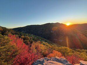 A mountainous landscape with a sunset.