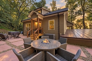 A house with a deck, outdoor seating, and a fire pit. - Asheville Retreat | Hot Tub • Game Loft • Views! (Asheville)