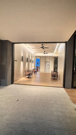 A spacious room with a high ceiling, two ceiling fans, and a door leading to another area. - Wake up to stunning KL skyline views in this bright 2-bedroom in Bukit Bintang.. (Kuala Lumpur)