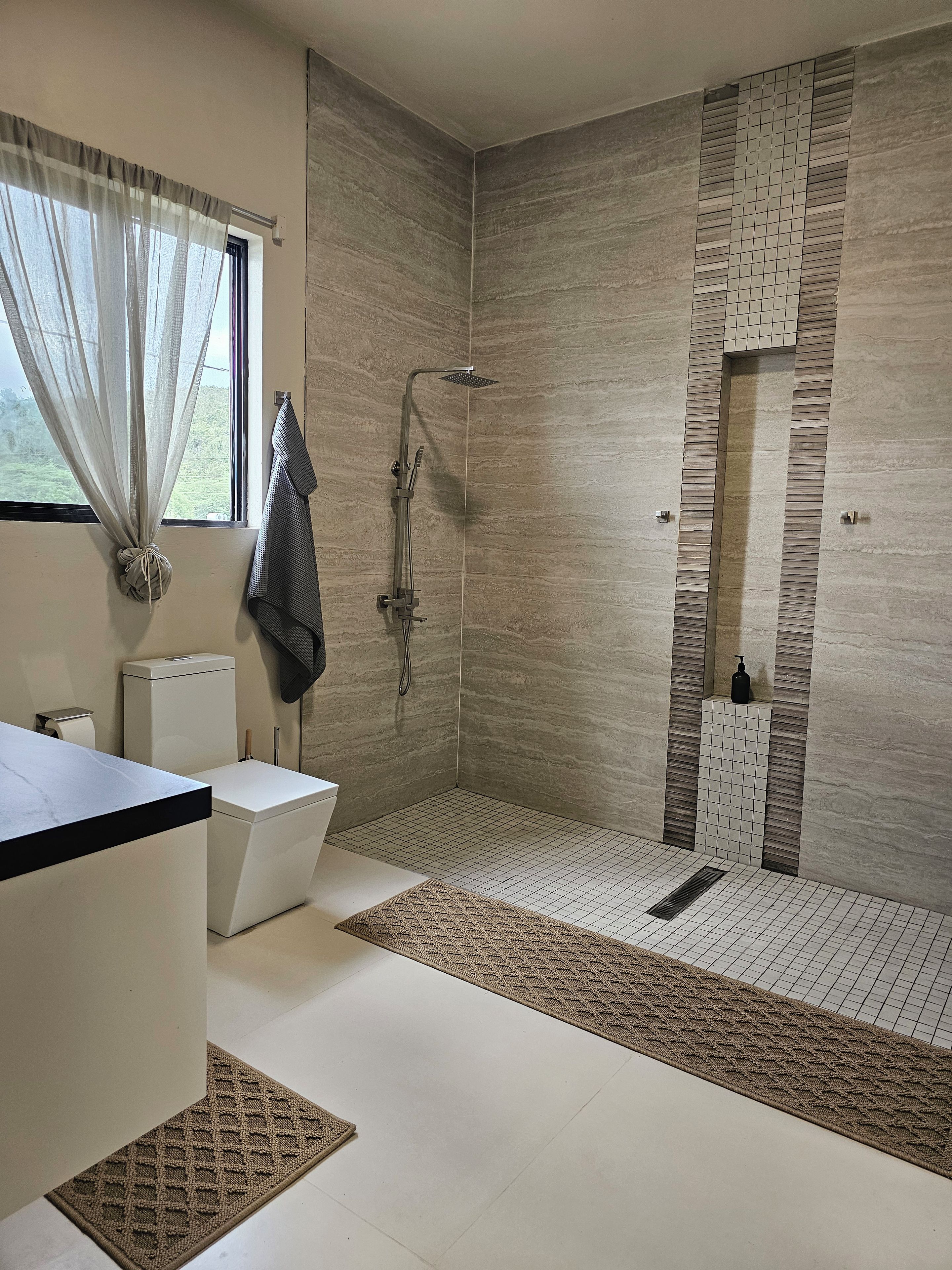 Ein modernes Badezimmer mit Dusche, Toilette und Waschbecken.