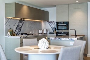 The modern kitchen has generous bench space and quality appliances for meals at home. - Jewel Designer Residence | Direct Ocean Views (Surfers Paradise)