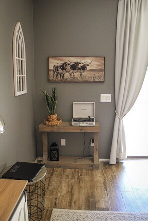 A room with a wooden bench, a framed picture of cattle, a small table with a plant, and a laptop. - Inside Anthem master plan community. 8 minute drive to TSMC. Close to I-17! (Phoenix)
