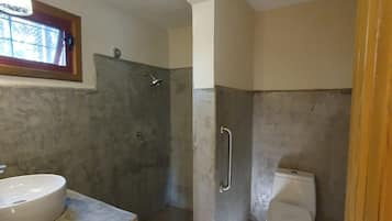 A bathroom with a shower, toilet, and sink.