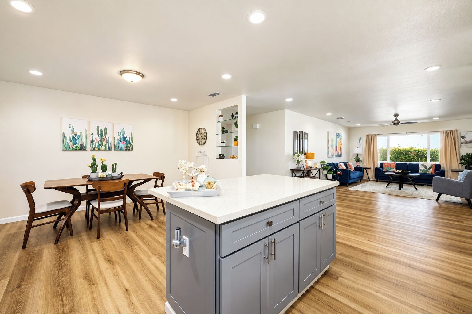 A spacious living area with a dining table, kitchen island, and seating area.