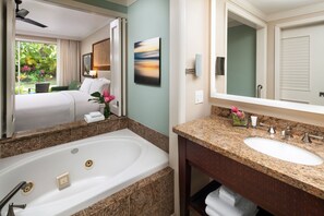 A hotel bathroom with a large bathtub, a sink, and a mirror. - Westin Princeville Ocean Resort Villas — 2BR Villa, Thanksgiving Week (Princeville)