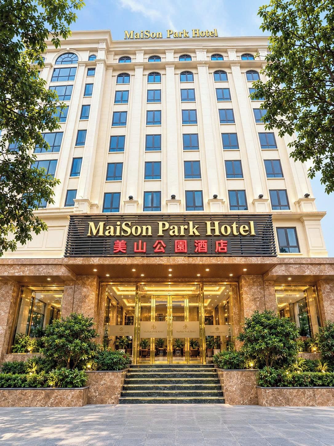 A hotel entrance with a sign reading 'MaiSon Park Hotel' and another in a different language.