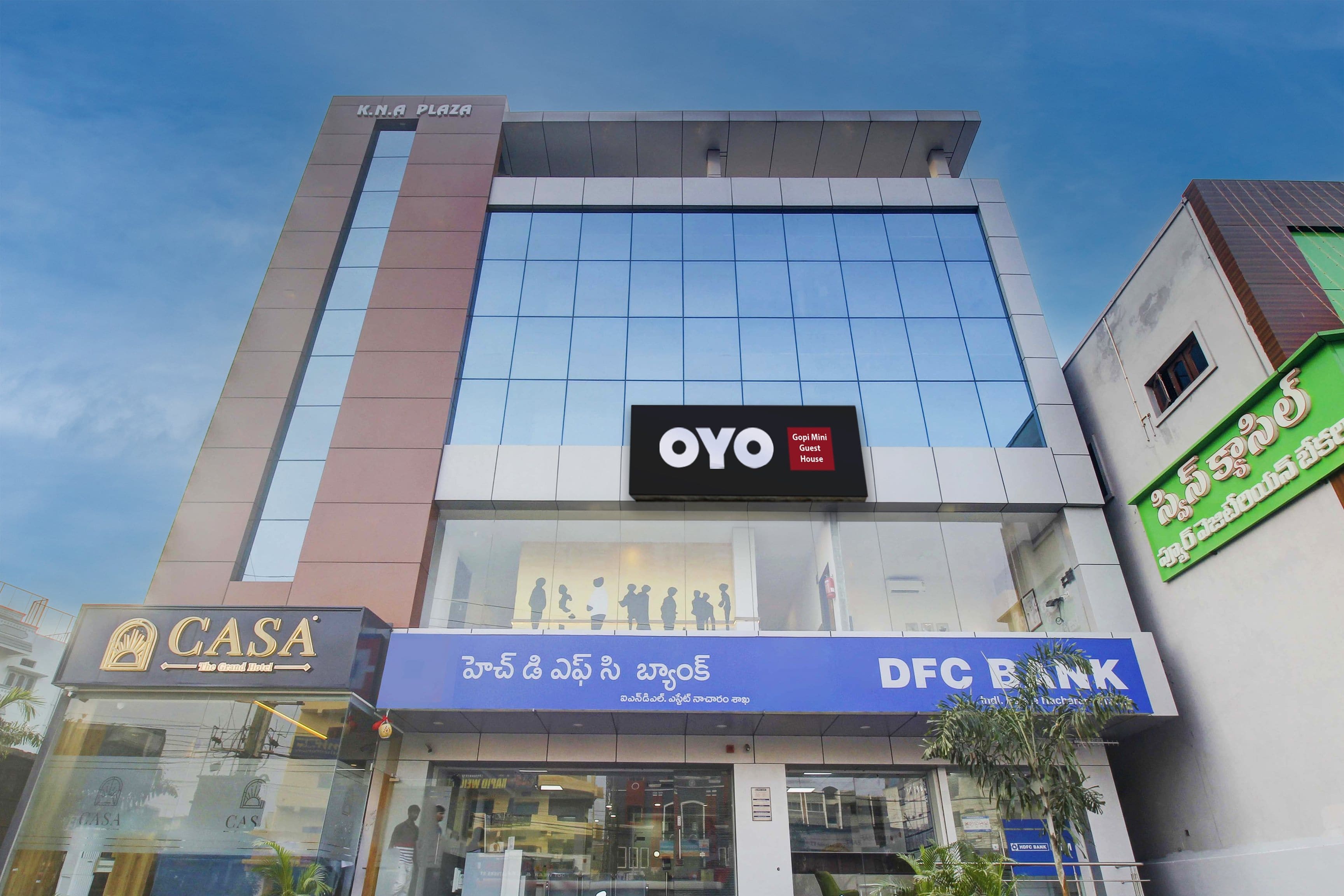 A multi-story building with a prominent OYO logo on the facade, indicating a hotel or guest house.
