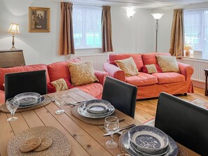 A furnished living room with a sofa set, dining table, and chairs. - 2 bedroom accommodation in Sherburn (Sherburn)