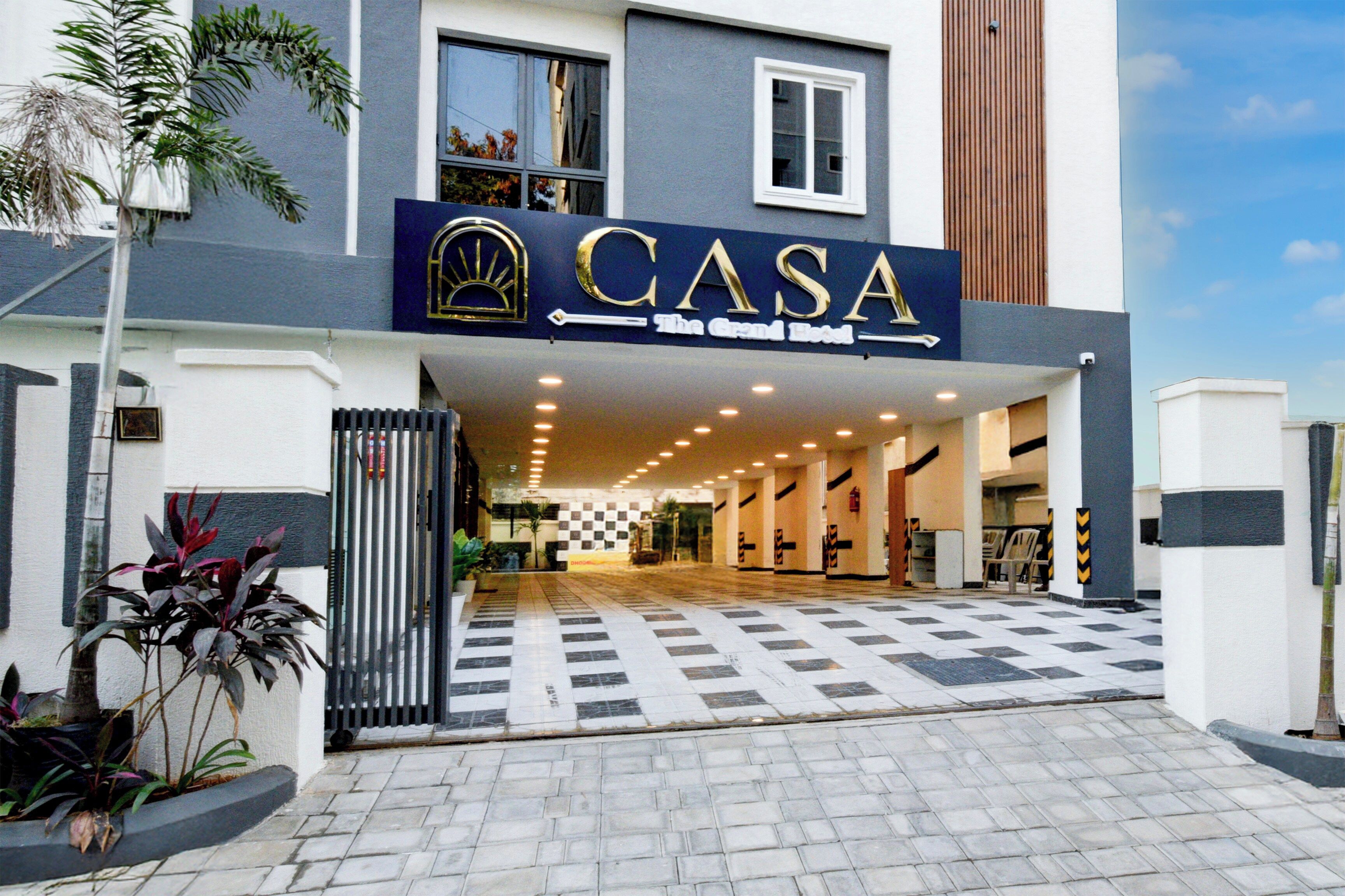A hotel entrance with a sign reading 'CASA The Grand Hotel'.