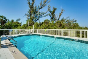 A clear blue swimming pool with a white deck and a white fence. - Closest Unit to Beach on Little Gasparilla Island (Placida)