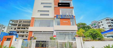 A multi-story building with a sign for 'CASA' and 'OYO TOWNHOUSE' indicating it is a hotel.