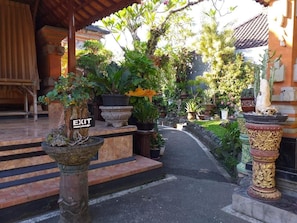 A pathway leading to a building entrance with a sign indicating an exit. - Puri Asri Bungalow Ubud (Ubud)