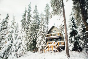 A cabin with a balcony, surrounded by snow-covered trees. - Adventure and Ski All Day, Sip, Soak, and Relax at Night in the Heart of Government Camp (Government Camp)