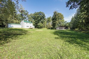 A grassy yard with a white house and a wooden shed. - Great for Groups! Spacious Milroy Escape (Milroy)