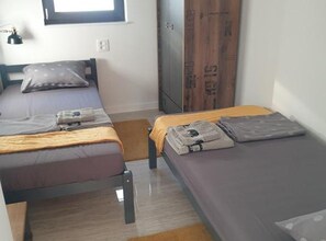 A room with two single beds, a wardrobe, and a window. - Retro Luxury Swim & Stay Apartment (Murter-Kornati)