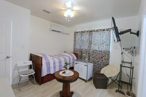 A compact room with a bed, a desk, a chair, a small table, and a ceiling fan. - 2 Mi to Universal Orlando! Quiet Studio Suite (Orlando)