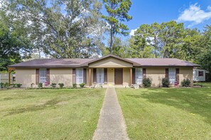 A two-story house with a front porch, a driveway, and a well-maintained lawn. - 2 Mi to MSU Campus: Starkville 4BR Home (Starkville)