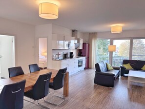 Eine moderne Wohnung mit Essbereich, Küche und Wohnzimmer.