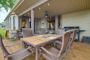 An outdoor patio with a table and wicker chairs, a grill, and a covered area with hanging lights. - Game Room, Private Dock! Grand Lake Group Retreat (Grove)