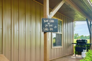 A covered outdoor area with a sign reading 'Keep Calm and get your lake on.' - Game Room, Private Dock! Grand Lake Group Retreat (Grove)