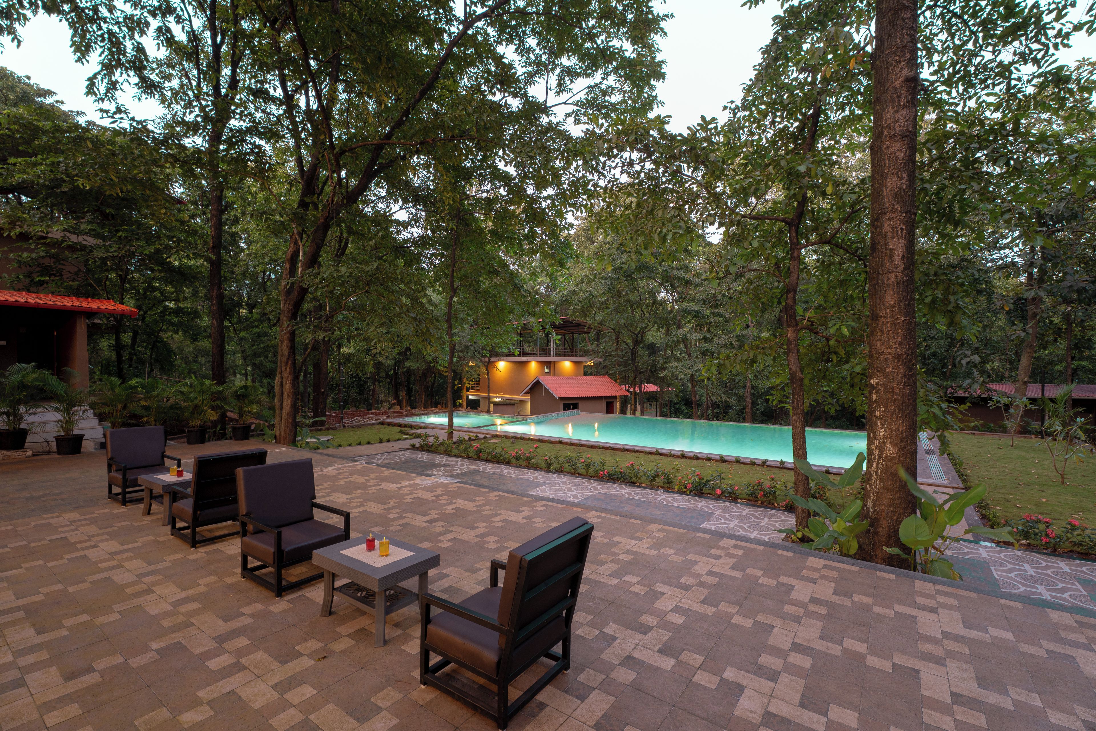 An outdoor patio with seating and a swimming pool.