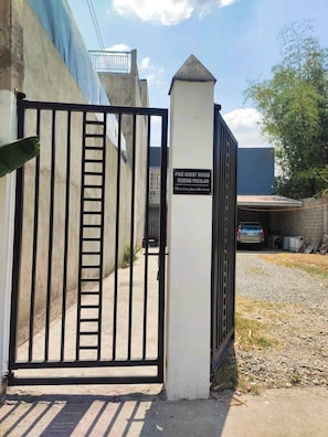 A gated entrance to a property with a sign reading 'PIKE GUEST HOUSE TEBENG PATALAN.' - Pike Guest House - Modern Western Style House (Dagupan)