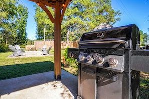 A barbecue grill with four burners, a chimney, and a control panel with various settings. - Hot Tub, Bar & Fire Pit! Bowdon Farm Cabin (Bowdon)